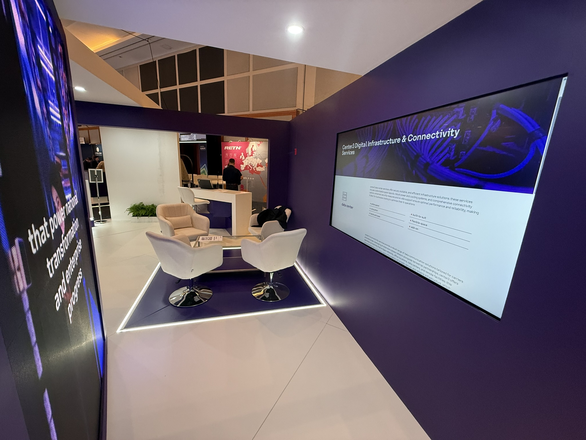 Center3 corporate exhibition booth with purple branding and meeting space